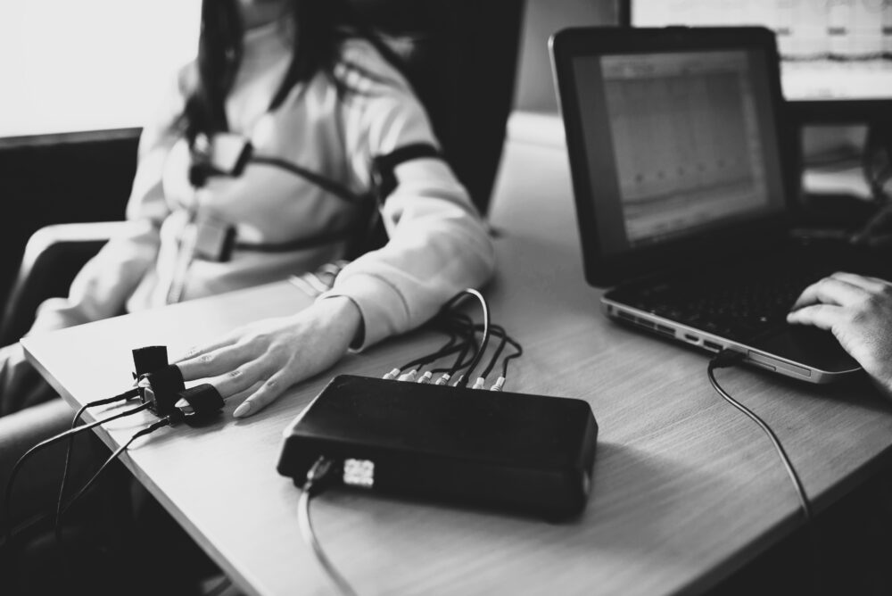 Polygraph examination — woman connected to lie detector test equipment