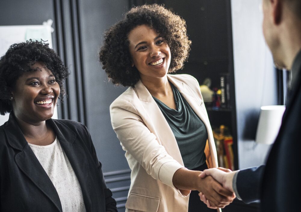 Business partners shaking hands after a successful polygraph background check